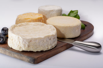 French AOC soft cow cheeses, crumbly Langres with washed rind structure, sharp Pie Angloys, camembert with strong taste and brie served as dessert after dinner
