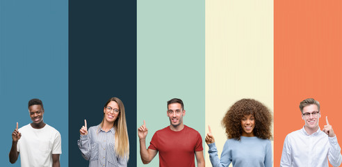 Group of people over vintage colors background showing and pointing up with finger number one while...