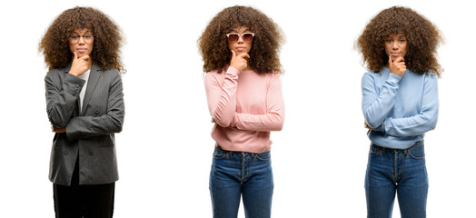 African american young woman wearing different outfits looking confident at the camera with smile with crossed arms and hand raised on chin. Thinking positive.