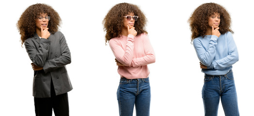 African american young woman wearing different outfits looking confident at the camera with smile with crossed arms and hand raised on chin. Thinking positive.