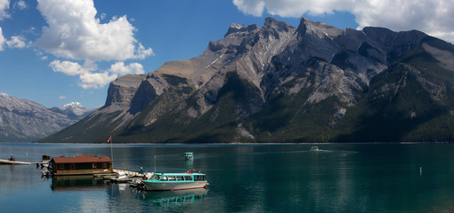 Boats at the dock with a beautiful Canadian Mountain Landscape in the background. Taken in  Lake...