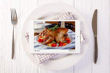 Food delivery concept with a digital tablet