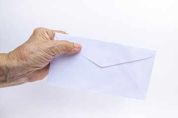 Senior woman's hand holding white envelope isolated on white background