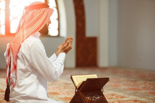 Religious muslim man praying inside the mosque