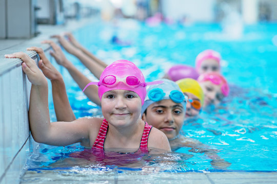 happy kids at the swimming pool. young and successful swimmers pose.