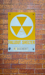 Fallout shelter in basement sign, vintage, on a brick wall