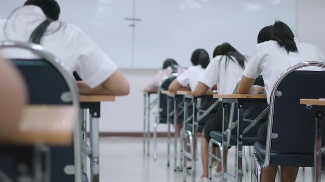 Asian students taking an exam in class room