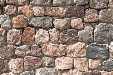 Colorful wall of volcanic stones closeup