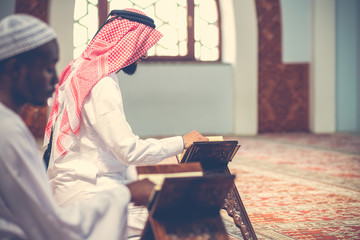 Obraz premium Two Religious muslim man praying inside the mosque