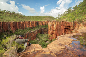 Landscape photographer photographing the iconic cliffs and high plateau of the Cockburn Range, El Questro Station, Kimberley, Australia.
