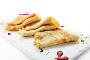 Folded Crepes, Blini or Pancakes on White Plate
