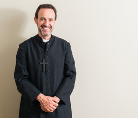 Senior priest religion man with a happy face standing and smiling with a confident smile showing...