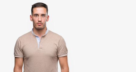 Fototapeta premium Handsome young man with a confident expression on smart face thinking serious