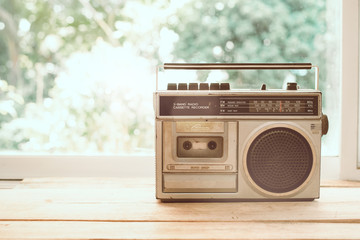 Photo of memorie and nostalgia. vintage radio or cassette reccorder in house. vintage color tone.