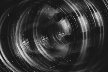 Monochrome multi exposition background of oil filter close up. Artwork from auto part in macro photography.