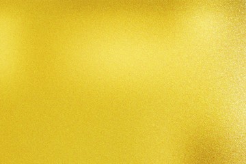 Texture of burn marks on gold metal sheet, abstract background