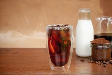 a glass of homemade cold cold brew coffee on wooden table