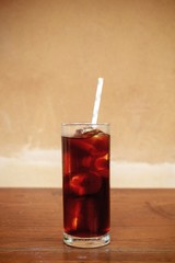 a glass of homemade cold cold brew coffee on wooden table