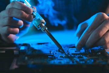 computer hardware engineering. technology science concept. developer soldering motherboard