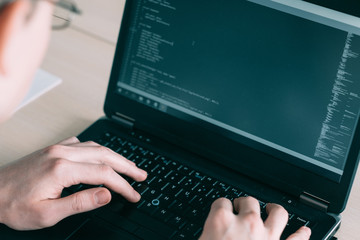 software developer working. man coding on his laptop. programming IT and modern profession concept.
