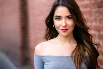 Beautiful young hispanic american woman with perfect skin, genuine casual smile