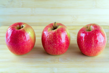 Red apple on wooden table.