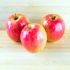 Red apple on wooden background.