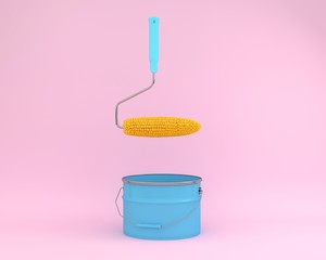 Creative idea layout of roller paint corn floating on pink background with blue paint bucket....