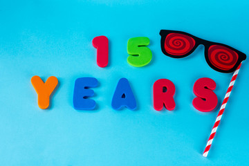 15 years old celebrating classic logo. Colored happy anniversary 15 th colored numbers on blue...