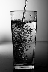 Water pouring into the clear glass