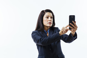 Portrait of business woman pressing on her cell phone, isolated on white studio background