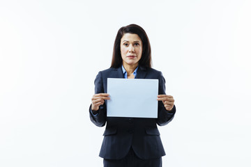 Portrait of a serious woman with tiny smile holding blank sign