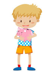 A young boy holding piggy bank