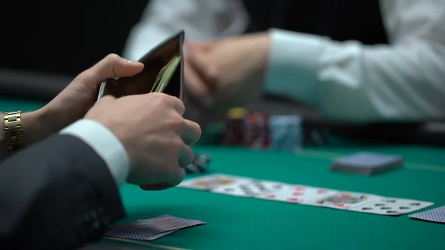 Business person betting all chips and money, risky poker game, bluff gambling