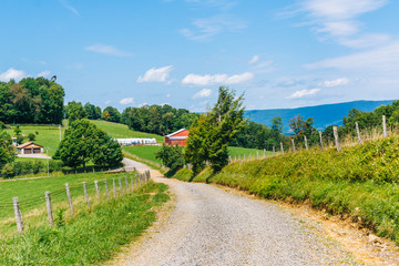 Fototapeta na wymiar Dirt road and farms in the rural Potomac Highlands of West Virginia