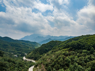 Fototapeta na wymiar Far view of Mount Tai in summer time, with its peak was surrounded by cloud 