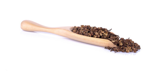 Dry Zanthozylum limonella Alston in wooden spoon on white background.