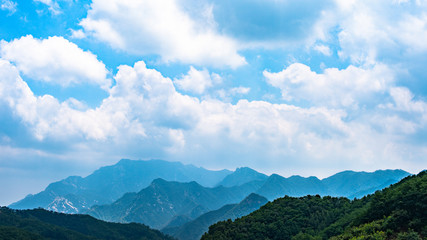 Far view of Mount Tai in summer time, with its peak was surrounded by cloud 