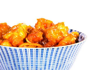 A close up of a bowl of Chinese Food, Orange Chicken and chow mein
