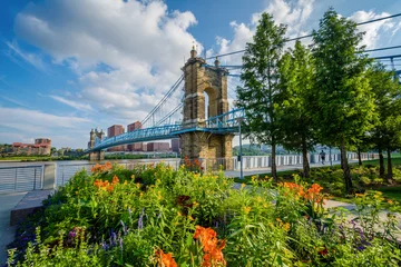 Fotobehang Flowers and the John A. Roebling Suspension Bridge in Cincinnati, Ohio © jonbilous