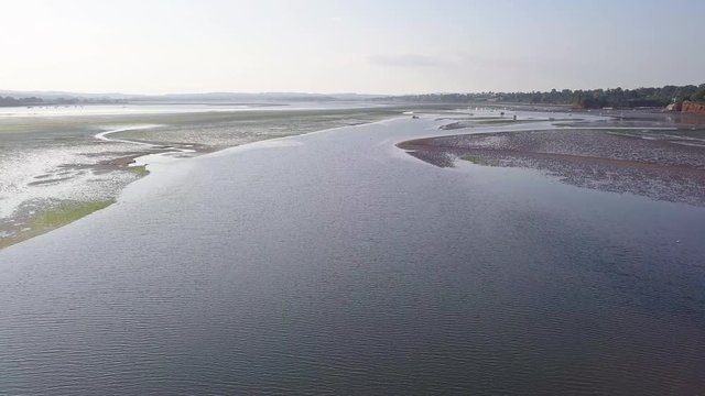 Sky view of mass of ocean water at the coastal town of Lympstone England. A buoy in the water is observed from the sky.