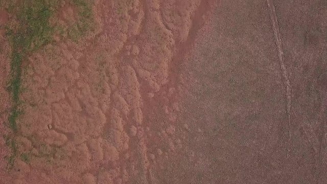 Aerial view of the red sand in the ocean off of the shores of historic town Lympstone England. Beautiful display of nature in the sea.
