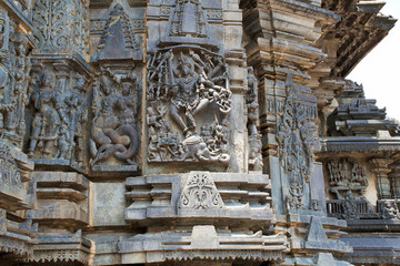 Ornate wall panel reliefs depicting, from left, Sundari, Nagas, Shiva as Gajasurasamhara, Bramha and Narayana on the extre right. Chennakesava temple, Belur, Karnataka. View from West.