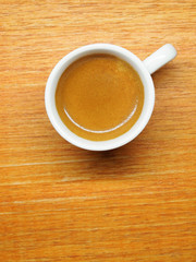 Cup of Espresso coffee on wood board background, Arabica with crema