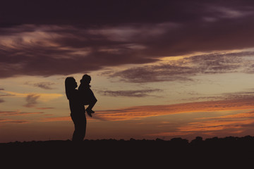 silhouette family and sunset