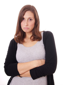 young woman sulking with crossed arms, isolated on white
