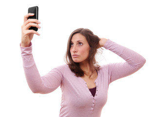 Fototapeta premium young woman making duckface while taking a selfportrait with her smartphone