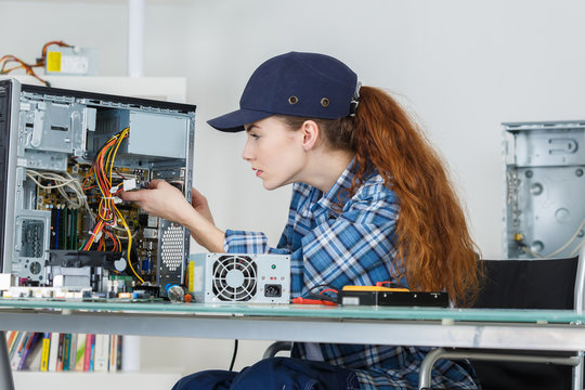 Computer Repair Engineer A Smiling Brunette Woman At Work