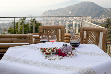Table on the terrace prepared for a romantic dinner overlooking the Gulf of Naples and Mount Vesuvius