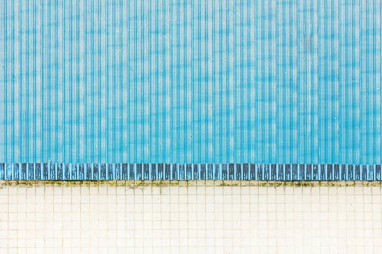 Grunge blue metal sheet with white tiles background.